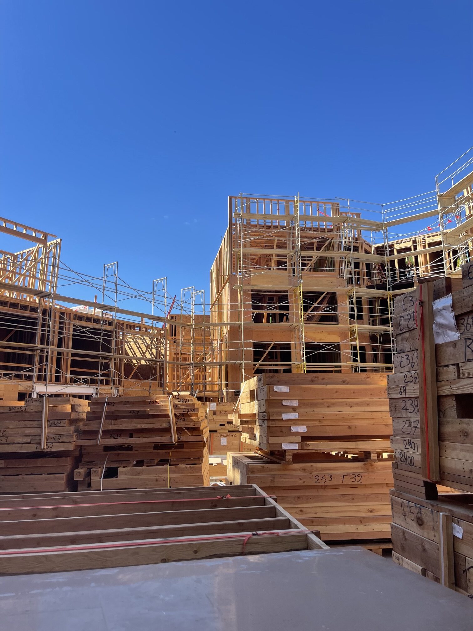 Wood-framed building under construction with scaffolding
